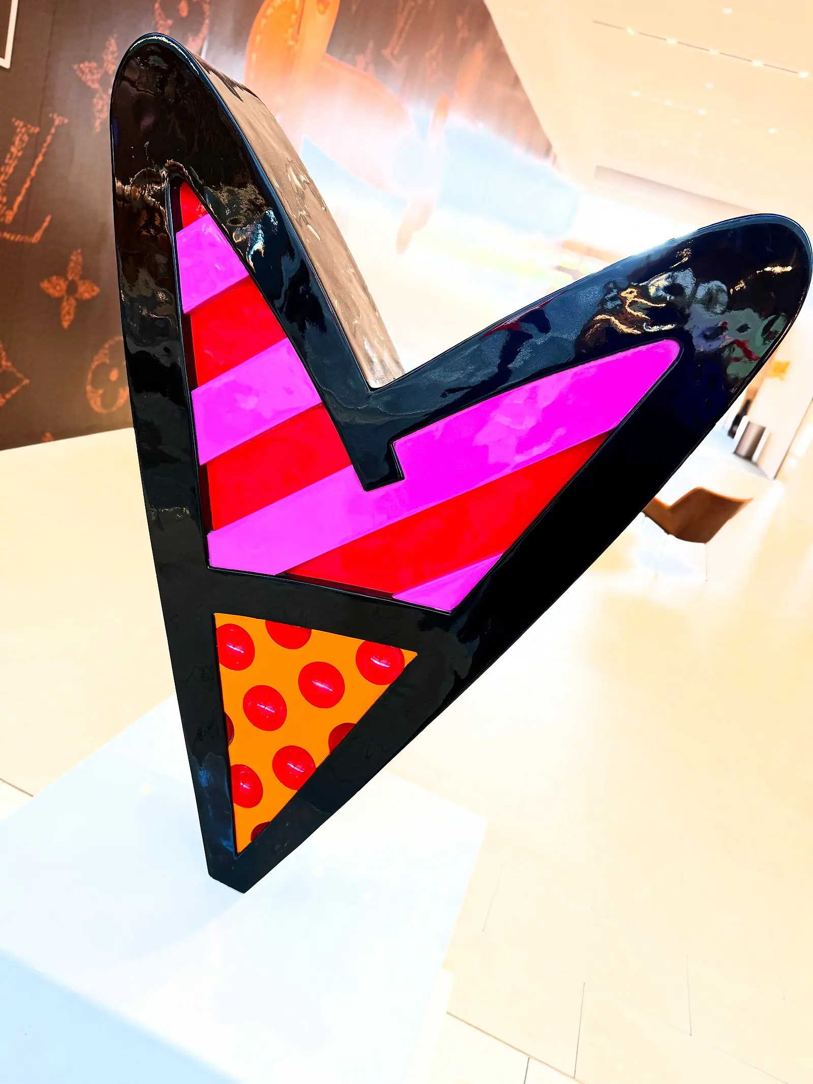 A colourful heart-shaped artwork mounted on a wall.